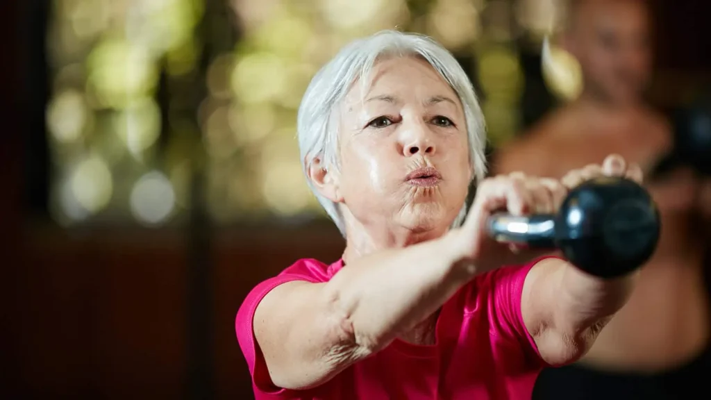 Toning Arms Without the Bulk: Is It Achievable? 1 Woman doing resistance band exercises for toned arms St Albans